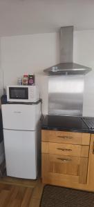 a small kitchen with a microwave and a refrigerator at Beautifully designed private studio in Telford near M54 J4 in Telford