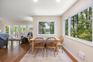 a living room with a table and chairs and windows at Heron Hideaway in Wilkesboro