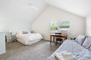 a bedroom with a bed and a desk with a table at Heron Hideaway in Wilkesboro