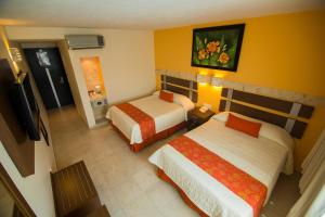 Giường trong phòng chung tại Hotel Tulija Palenque