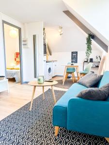 sala de estar con sofá azul y mesa en NEW: Le Lumineux face à la gare !, en Guingamp
