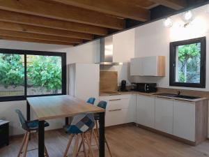- une cuisine avec une table et des chaises dans la chambre dans l'établissement La Remise de Francillon, à Francillon-sur-Roubion