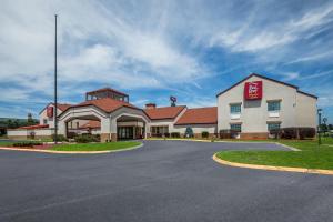 a hotel with a sign on the side of a road at Red Roof Inn PLUS+ & Suites Knoxville West - Cedar Bluff in Knoxville