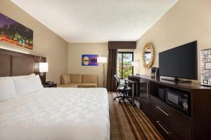 a hotel room with a bed and a flat screen tv at Holiday Inn Washington-Dulles International Airport, an IHG Hotel in Sterling