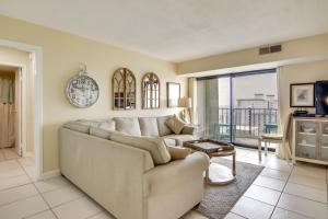 a living room with a couch and a clock on the wall at Beachfront Ocean City Condo with Pool and Views! in Ocean City