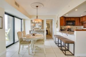 a kitchen and dining room with a table and chairs at Beachfront Ocean City Condo with Pool and Views! in Ocean City
