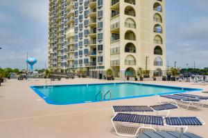 a swimming pool in front of a large building at Beachfront Ocean City Condo with Pool and Views! in Ocean City