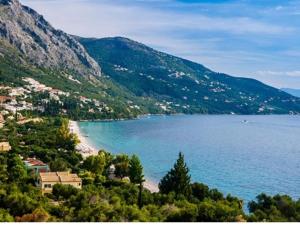 a view of a beach next to a mountain at Fiorentina apartments in Barbati