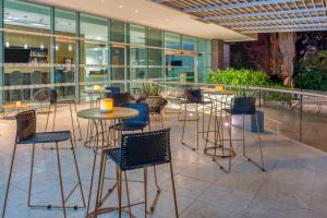 a patio with tables and chairs in a building at Four Points by Sheraton Barranquilla in Barranquilla