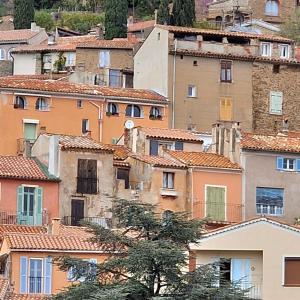 a group of buildings in a city with trees at Boulevard du Soleil in Bormes-les-Mimosas