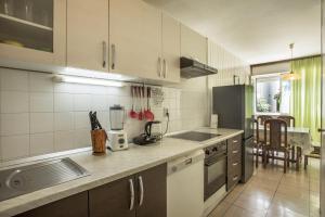 a kitchen with white cabinets and a counter top at Apartment Jase in Split