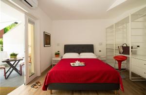 a bedroom with a red bed with a red blanket at Nice Hotel Bibione in Bibione