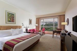 a hotel room with a bed and a large window at ITC Kakatiya, a Luxury Collection Hotel, Hyderabad in Hyderabad