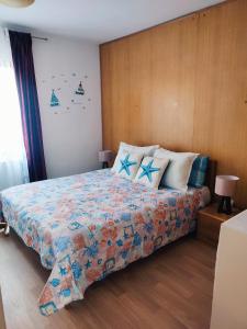 a bedroom with a bed with two blue stars on it at Apartments Novigrad in Novigrad Istria