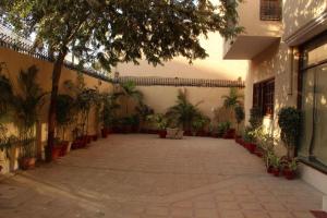 a courtyard with potted plants in a building at Hotel Inn PECHS in Karachi