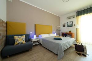 a bedroom with a bed and a chair in it at Nice Hotel Bibione in Bibione +68 photos