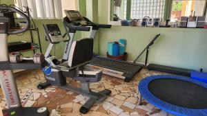 a room with a gym with a treadmill and a exercise bike at Sadie's Bed and Breakfast / Hotel in Tijuana