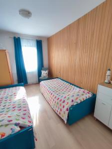 a small bedroom with two beds and a window at Apartments Novigrad in Novigrad Istria