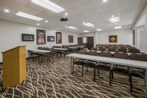 a room with rows of tables and chairs at Red Roof Inn PLUS+ & Suites Knoxville West - Cedar Bluff in Knoxville