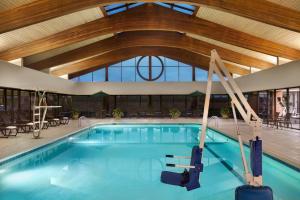 a pool in a hotel with a wooden ceiling at Holiday Inn Washington-Dulles International Airport, an IHG Hotel in Sterling