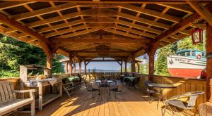 a large wooden deck with a boat on it at The Cabins at Alert Bay in Alert Bay