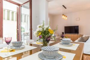 a living room with a table with two chairs and a couch at Tinel Apartment Sukosan in Sukošan