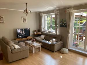 a living room with a couch and a tv at Chalupa u Pavelků 