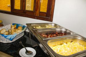 two trays of food on a counter in a kitchen at Pousada Farol do Porto Nova ADM 2026 in Porto De Galinhas