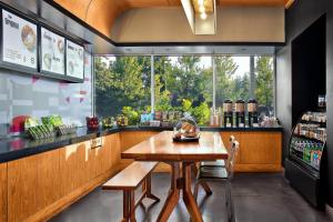 a kitchen with a wooden table and a window at Aloft Arundel Mills BWI Airport in Hanover