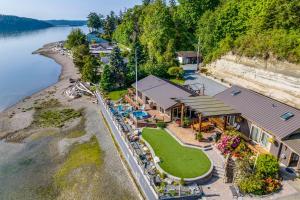 an aerial view of a house next to the water at Similk Bay Retreat with Deck, Fire Pit and Hot Tub! in Anacortes