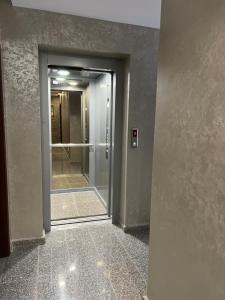 a hallway with a door leading into a room with a mirror at Stamatovi Family Hotel in Pomorie