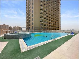 a large swimming pool on the roof of a building at Lake View All Bills Included Fully furnished in Dubai