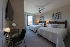 a hotel room with two beds and a flat screen tv at Luxury Getaway at The Village in Columbus