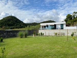 a house on a hill with a yard at CaLoura 76 in Lagoa