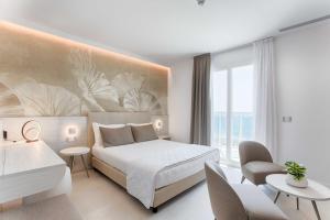 a bedroom with a bed and a large window at Hotel Mirafiori in Lido di Jesolo