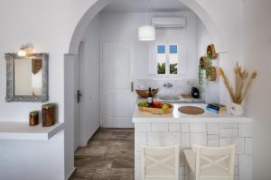 a kitchen with a counter with a bowl of fruit at Sol Mare Salis in Kamari