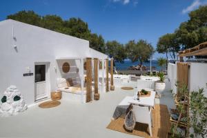 a white house with a patio with a view of the ocean at Sol Mare Salis in Kamari