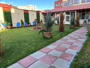 a patio with chairs and plants in a yard at Valentino´s Residence in Constanţa