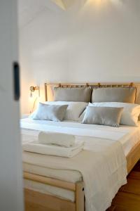 a large bed with white sheets and pillows on it at Sweet House Elisa in Treglio