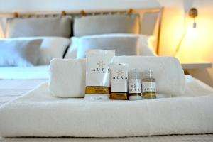 a pile of towels and cosmetics on a bed at Sweet House Elisa in Treglio