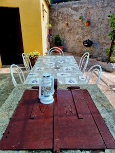 a red table with a candle on top of it at House Lopica in Senj +22 photos