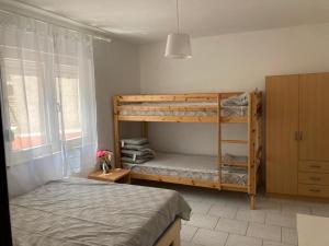 a bedroom with two bunk beds in a room at Apartmani Fijan in Pag