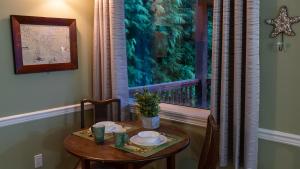 a table and chairs with a table and a window at Wild Pacific Guest Suites in Ucluelet +30 photos