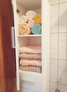 a towel rack with towels in a bathroom at Apartments Novigrad in Novigrad Istria