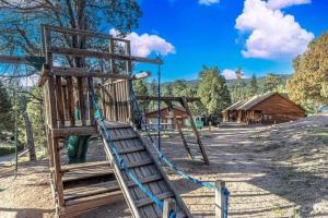 an empty playground with a ladder and a swing at Cabin #1 Buffalo Herd -Pet Friendly - Sleeps 6 - Playground & Game Room in Payson