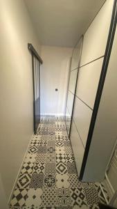 a hallway with a tiled floor in a building at Grand studio refait à neuf ! in Yerres