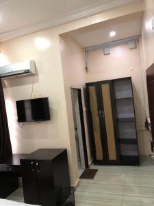 a room with a flat screen tv on the wall at T Golden Villa in Enugu