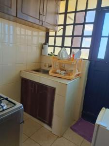 a small kitchen with a sink and a stove at Tashie homes in Machakos