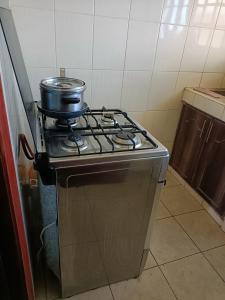a stove with a pot on top of it in a kitchen at Tashie homes in Machakos