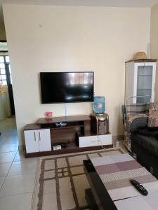 a living room with a flat screen tv on a wall at Tashie homes in Machakos